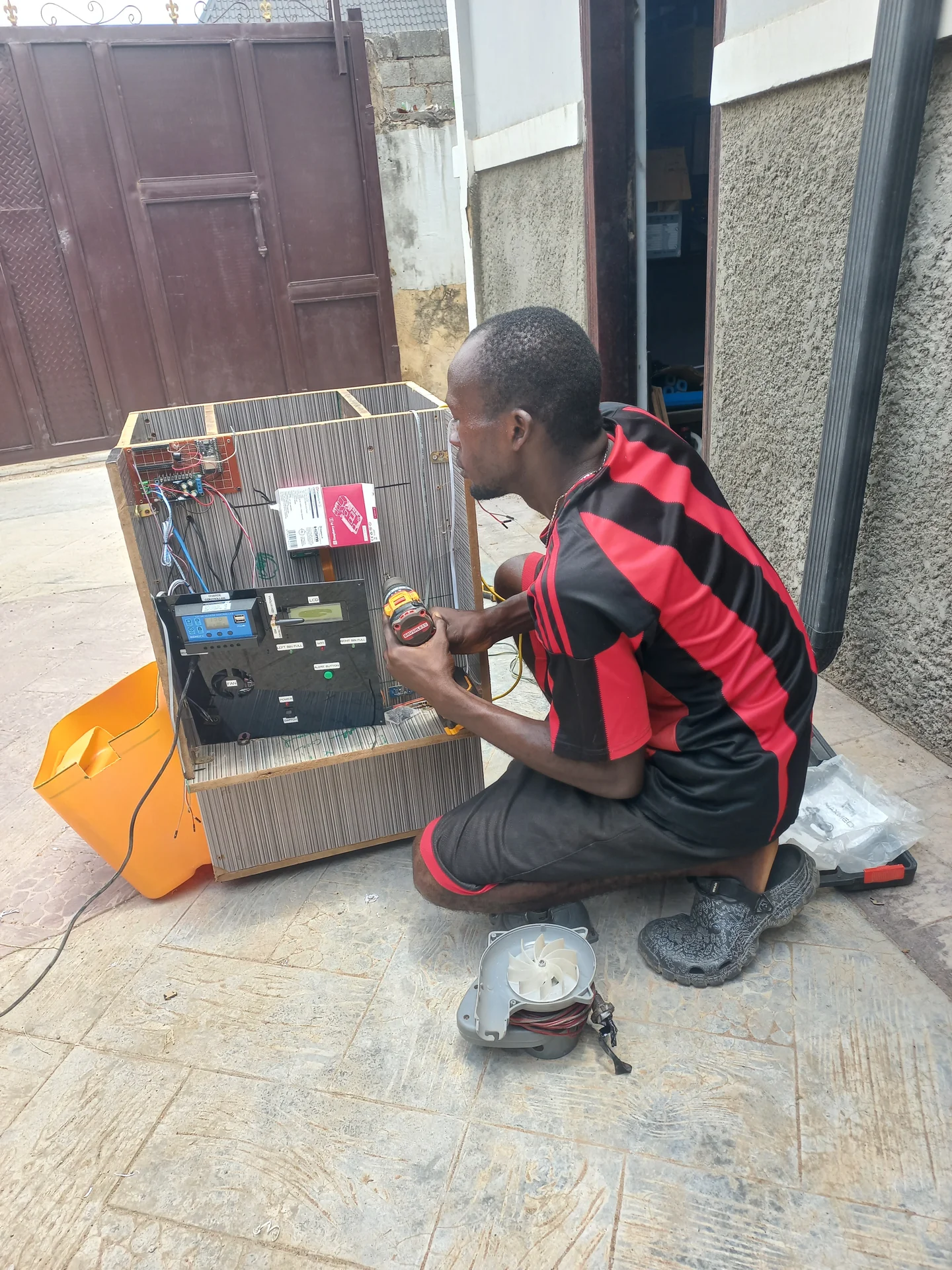 Closer shot of the builder with face visible while concentrating on the wiring work