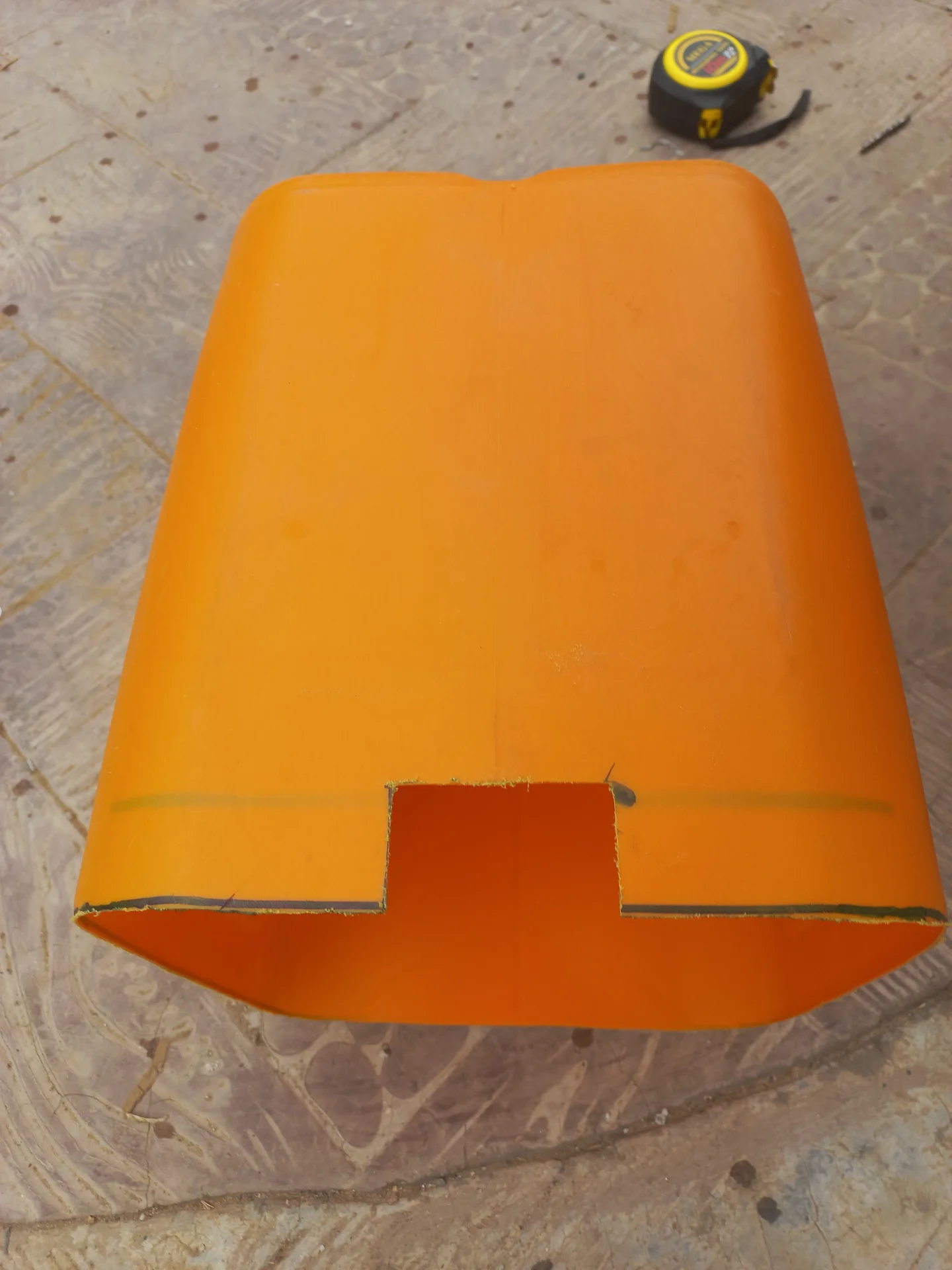 A slot cut into the side of a jerry can piece to allow sensor cables to pass through