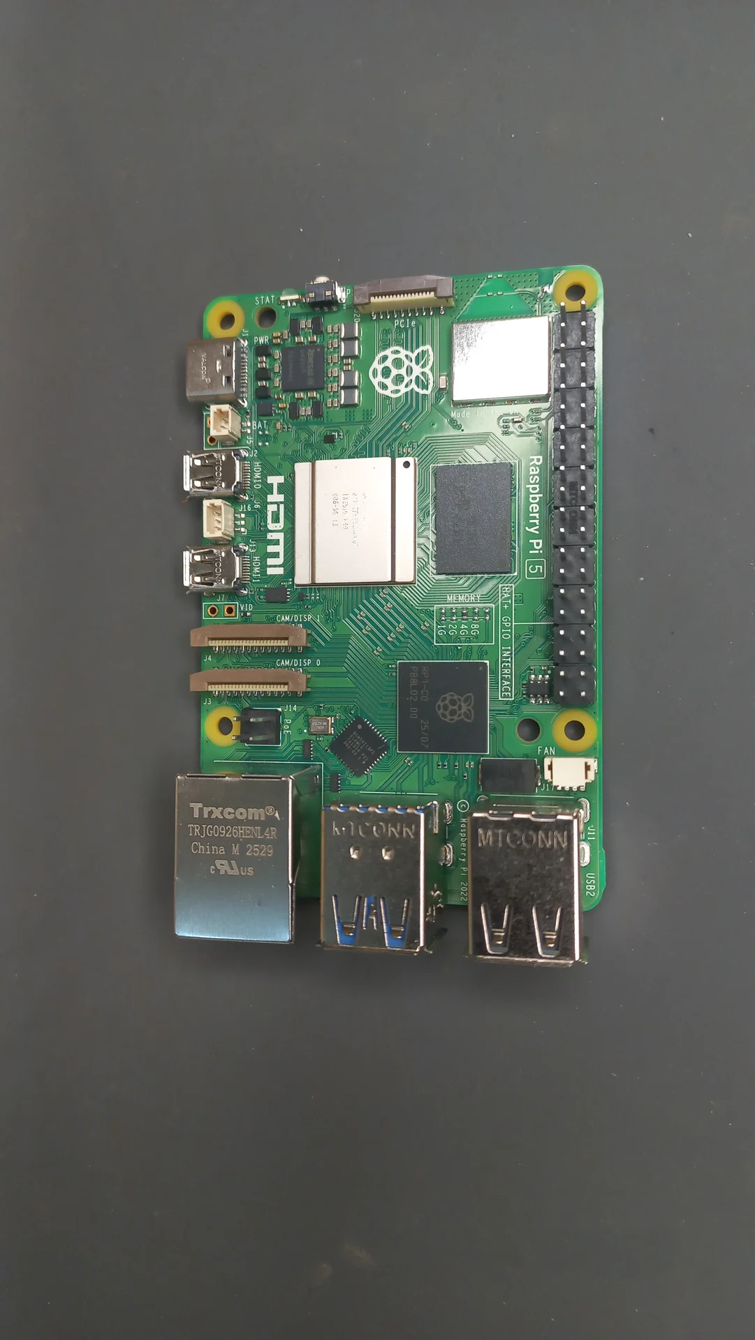 Raspberry Pi 5 (4 GB) board laid flat, showing the BCM2712 chip, GPIO header, USB ports and the Raspberry Pi logo