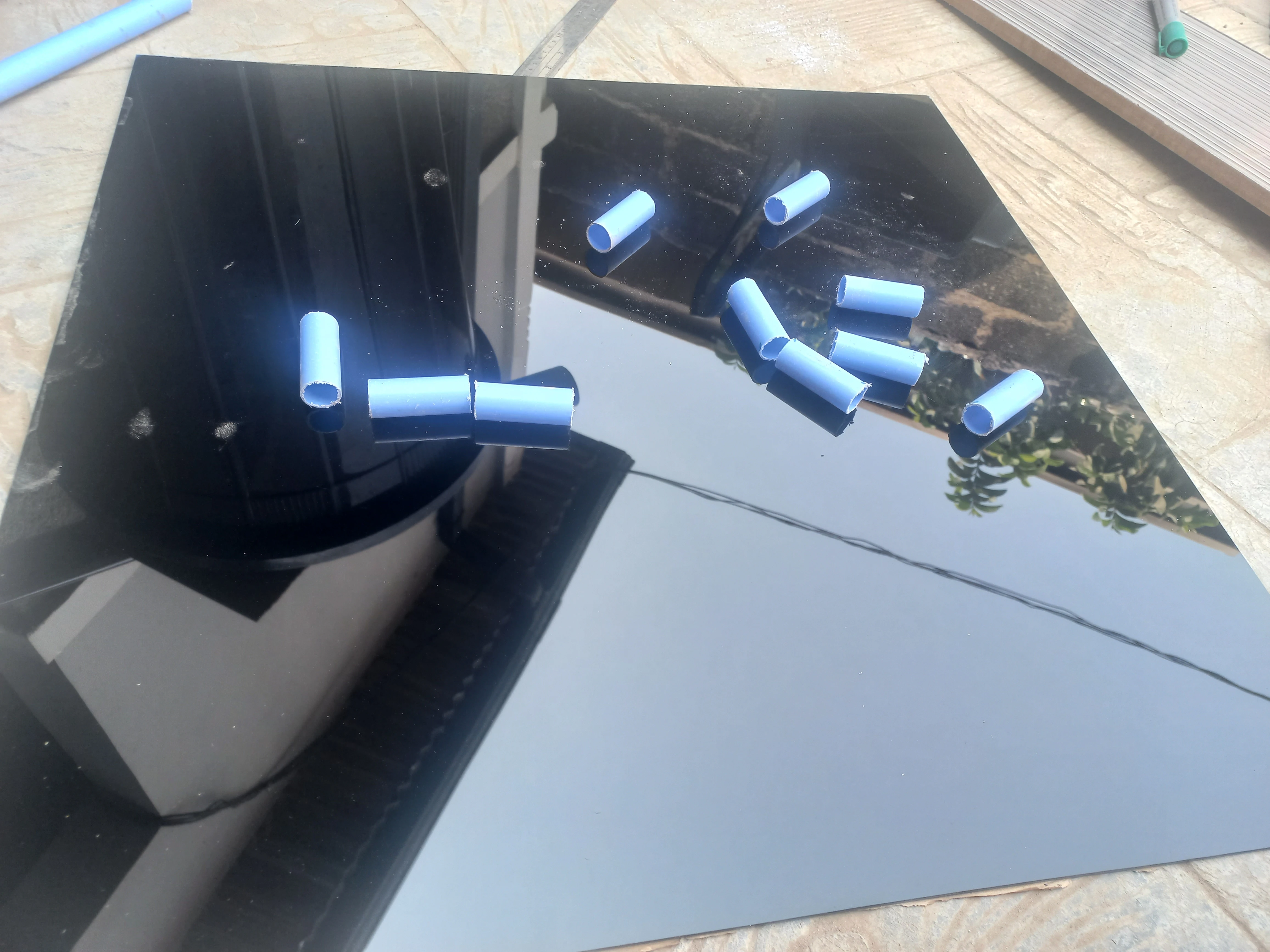 Black acrylic sheet and PVC pipes for road surface and base legs