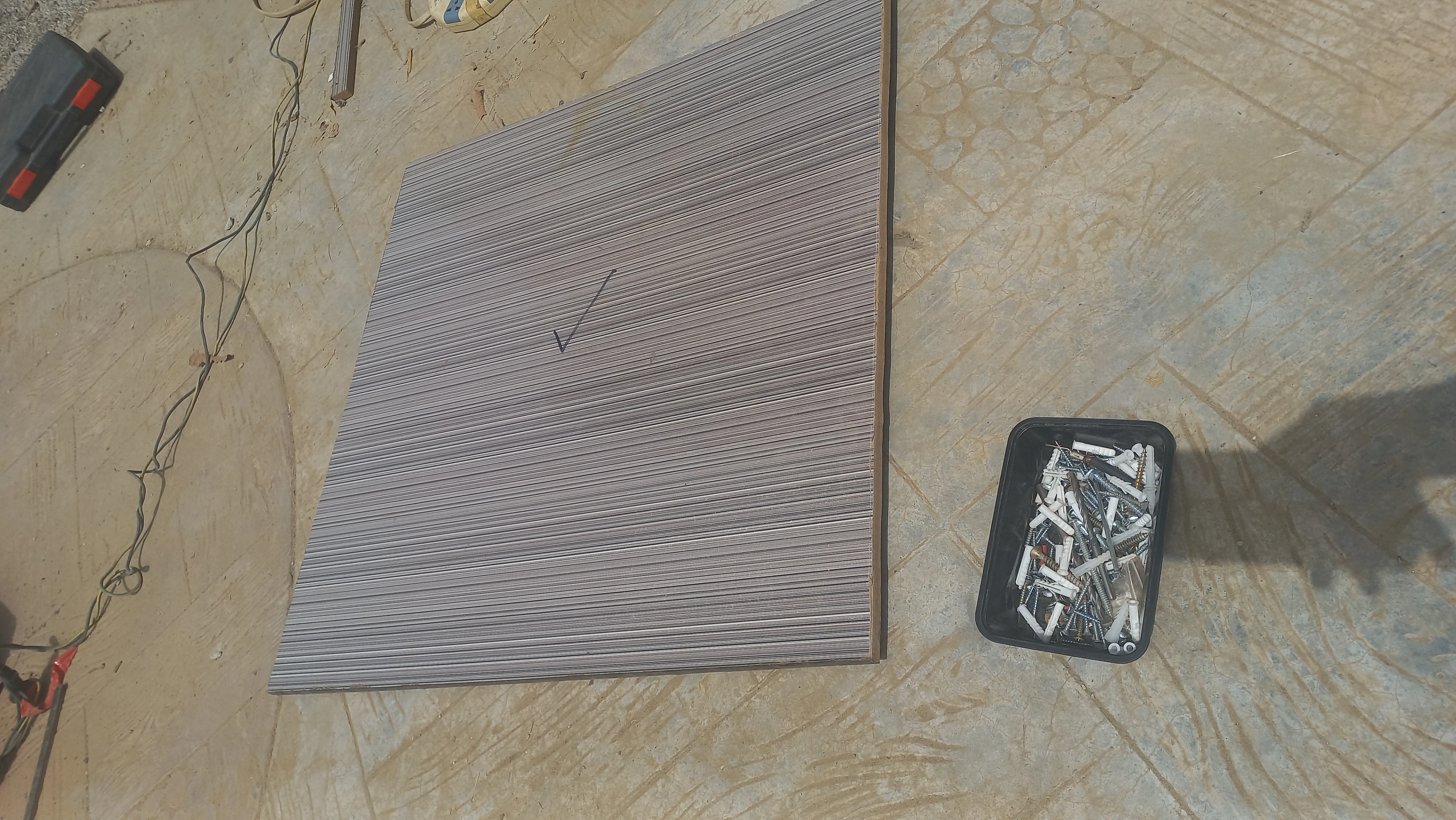 Composite board panel with nail positions marked for enclosure assembly