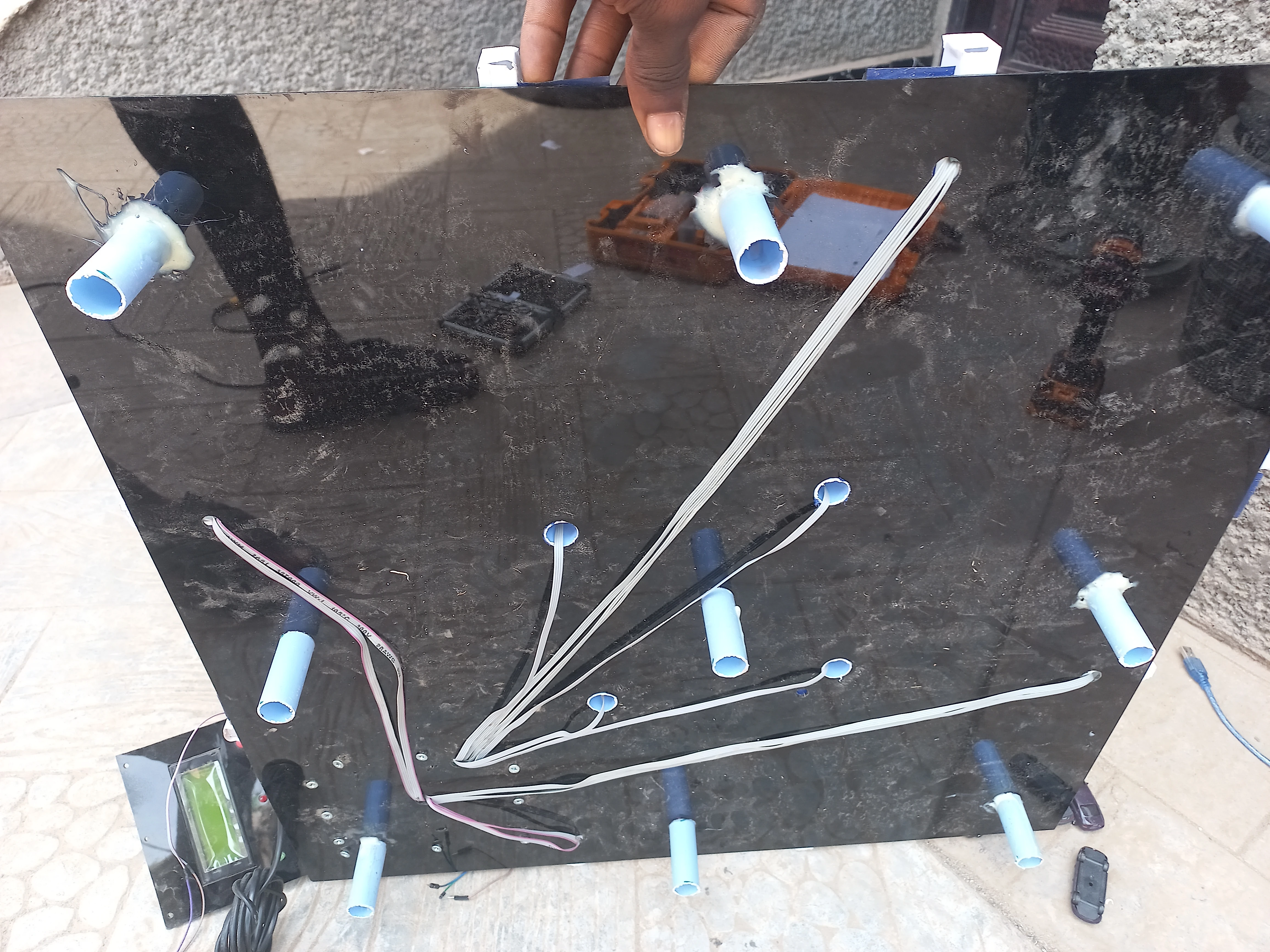 Underside of model showing PVC stub legs and wiring routed to control box