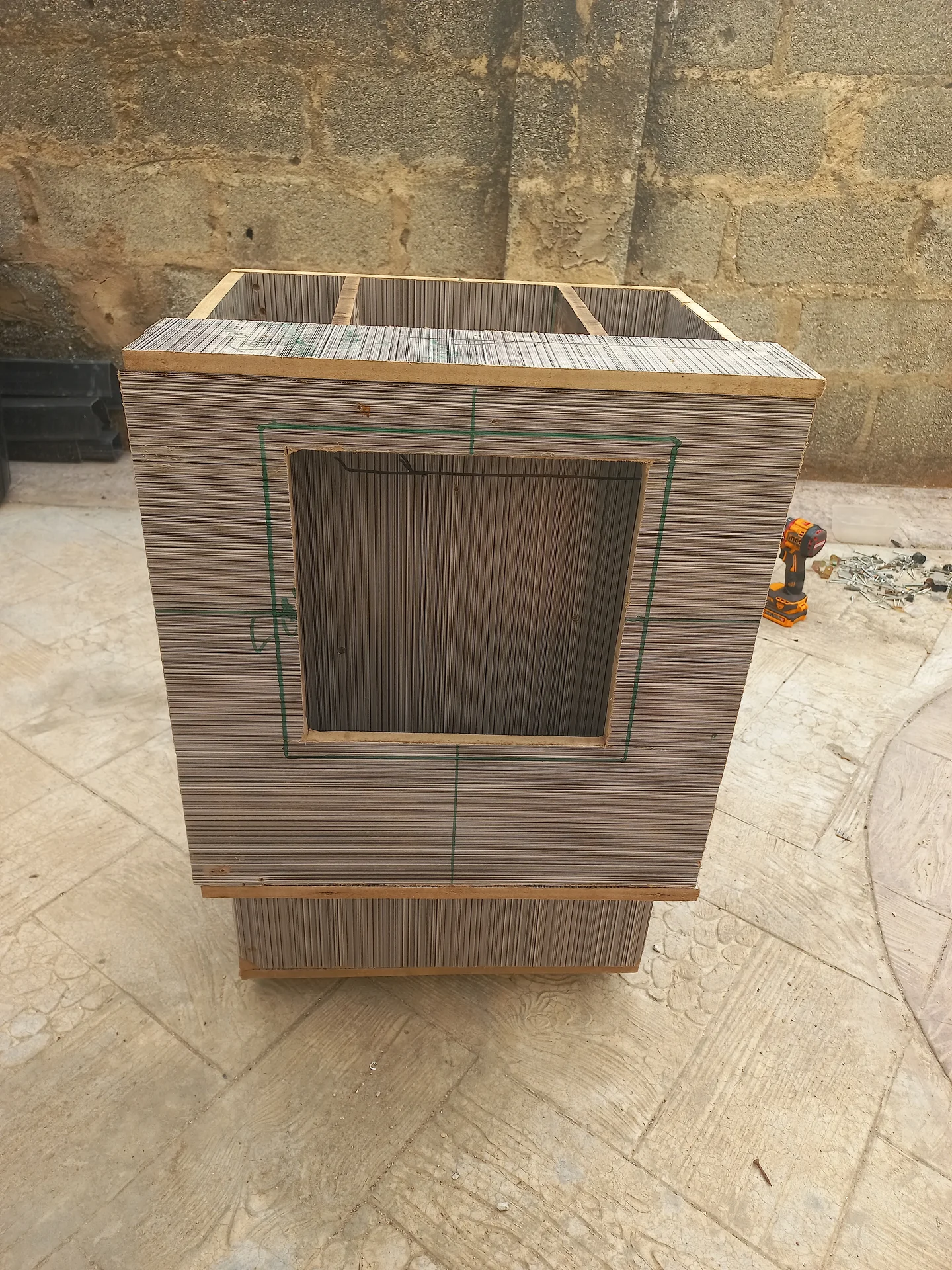 Front view of the bin exterior showing the large rectangular cutout on the front panel marked with green measurement lines, with the open top compartments visible above