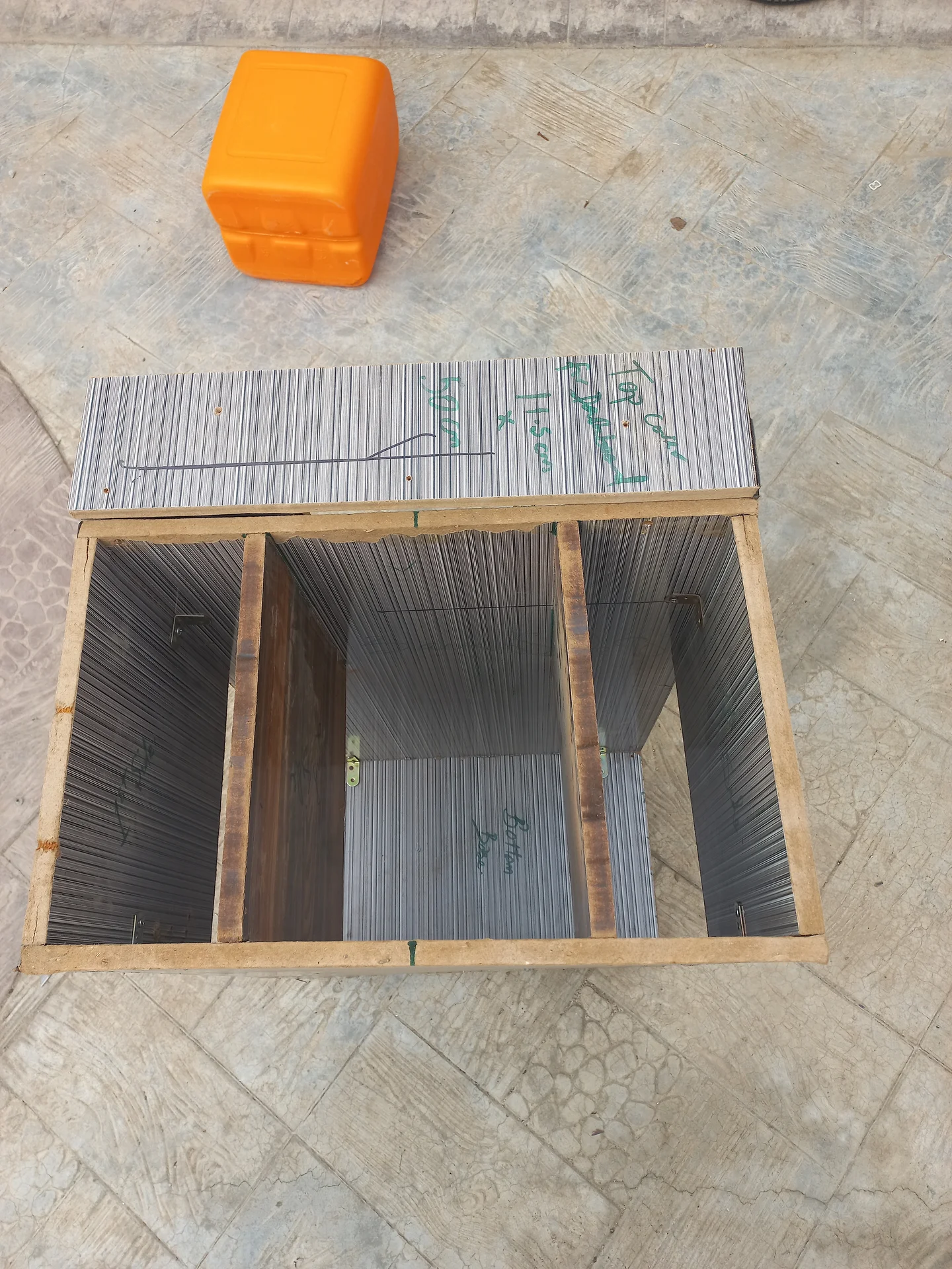 Top-down view into the open bin showing three side-by-side sorting compartments separated by two internal dividers
