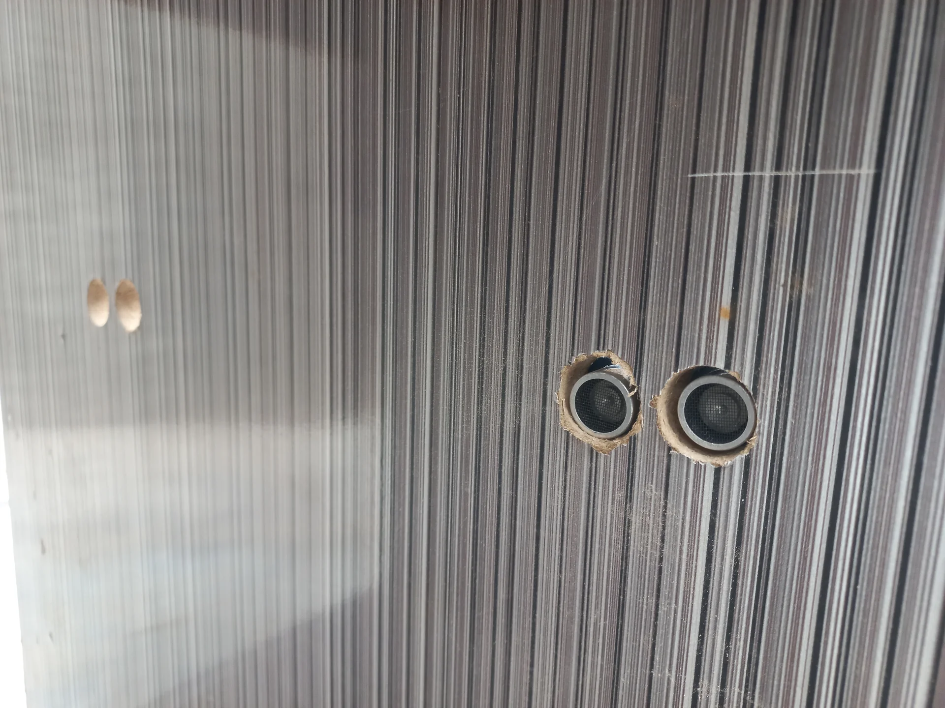 Side view of the bin wall showing the sensor holes from the outside of the enclosure