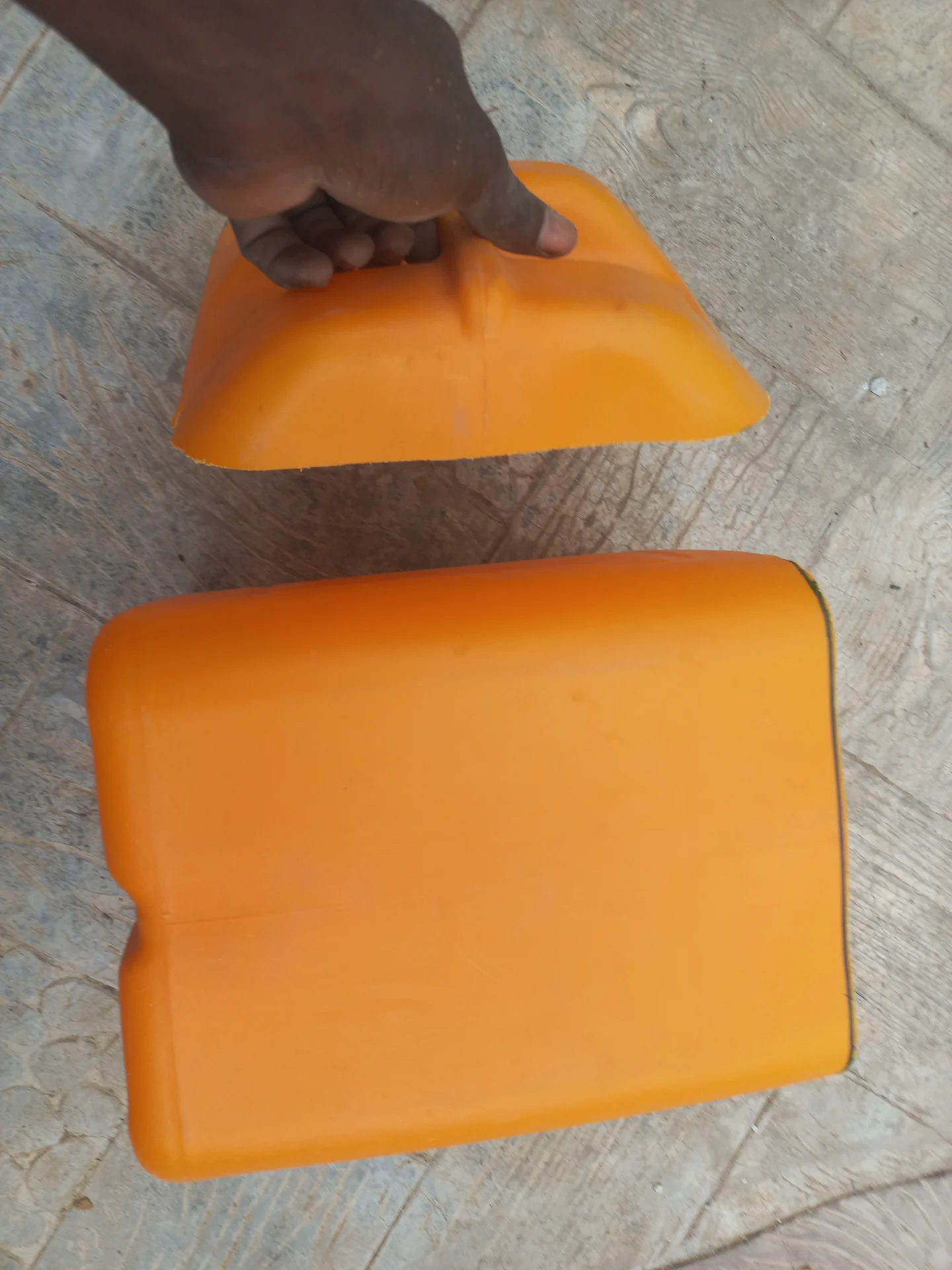 The cut jerry can pieces laid out, showing the sections that will be placed inside the compartments as liners