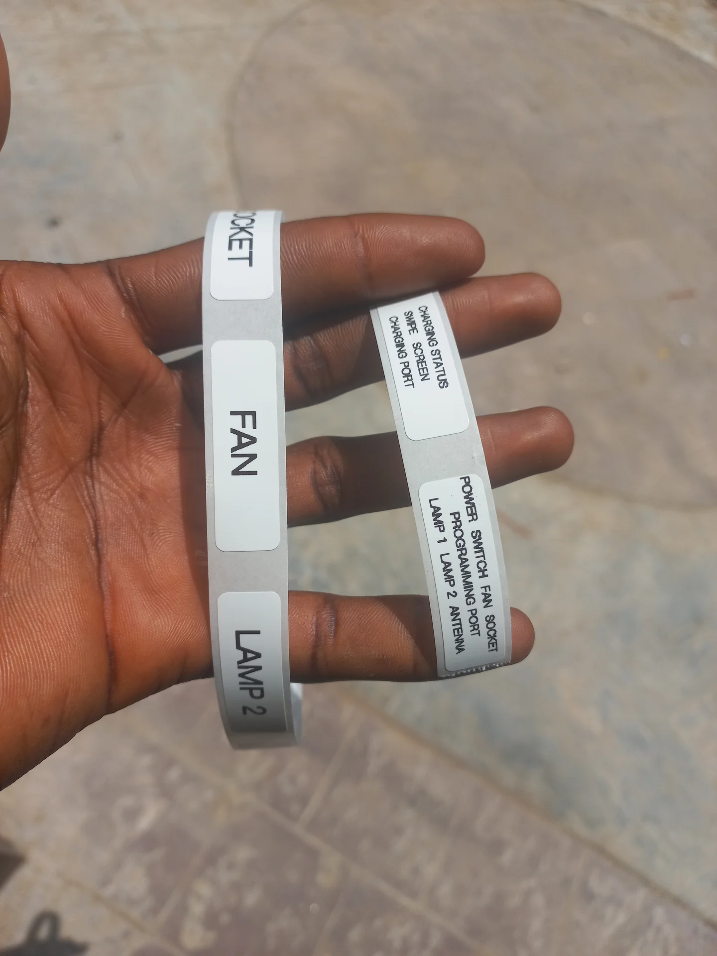 Printed label strips for the control panel, showing text including FAN, LAMP 1, LAMP 2, SOCKET, CHARGING STATUS, POWER SWITCH, PROGRAMMING PORT and ANTENNA