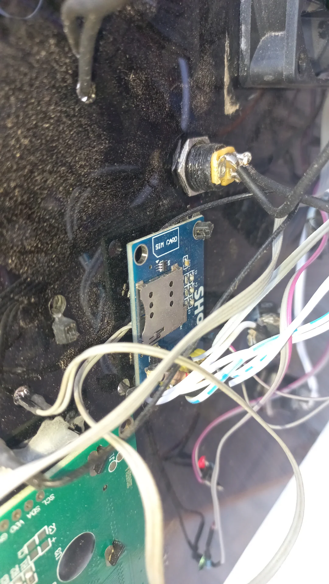 SIM800L module inside the electronics bay with the SIM card slot visible, confirming the GSM module is installed