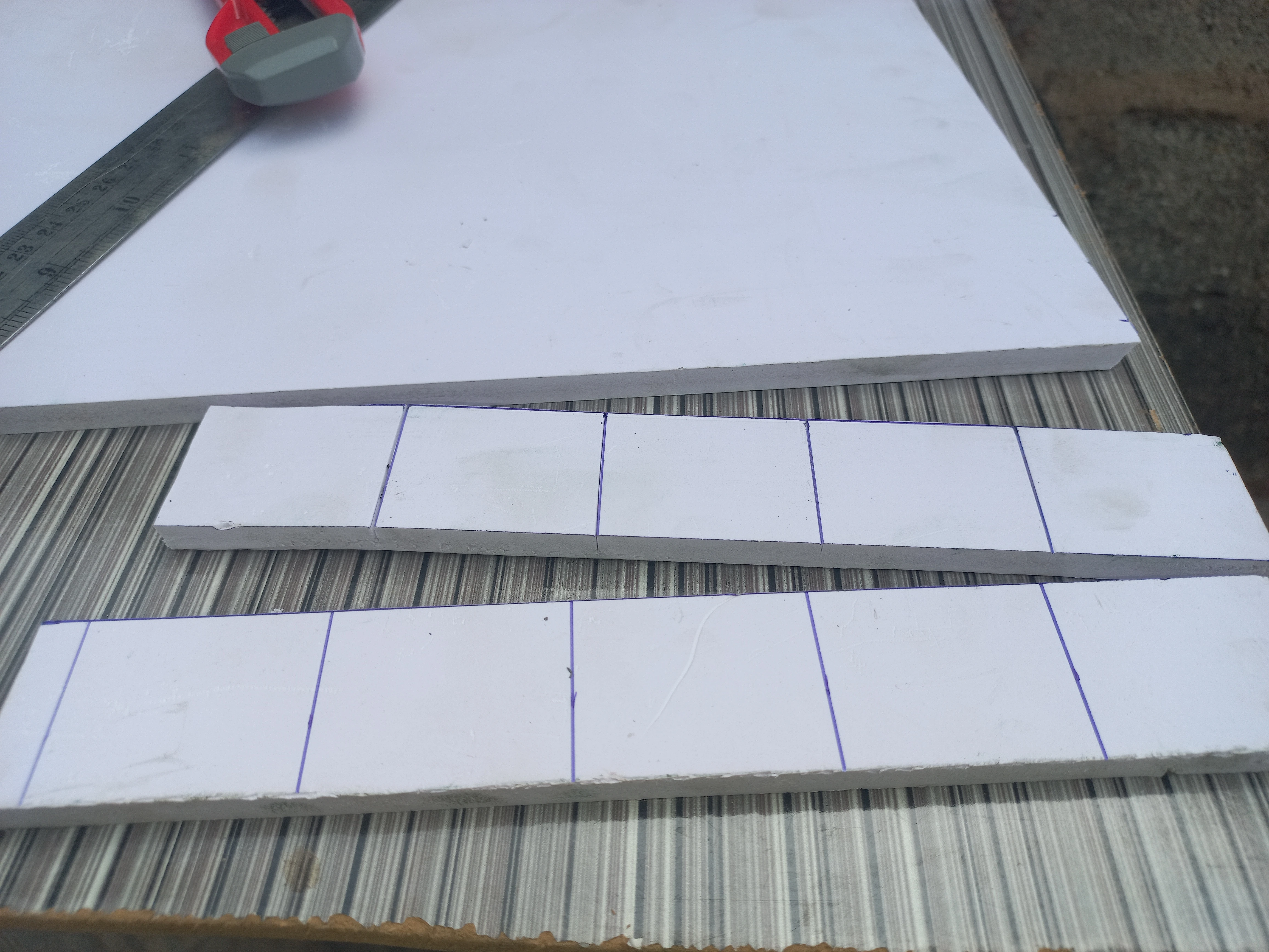 Strips of PVC board cut to width, ready for road surface arm construction