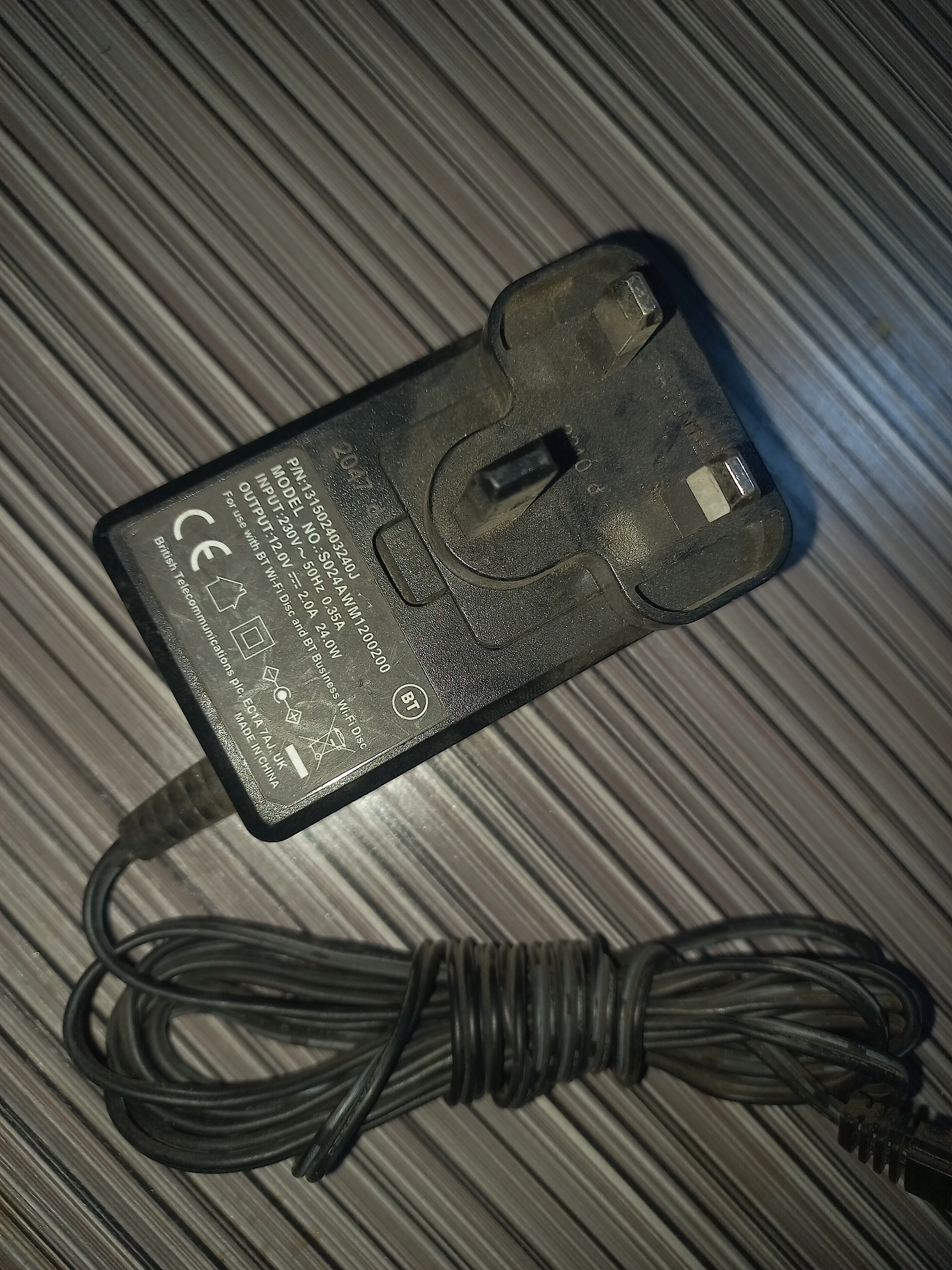BT-branded 12 V/2 A AC adapter, the primary power supply for the road unit