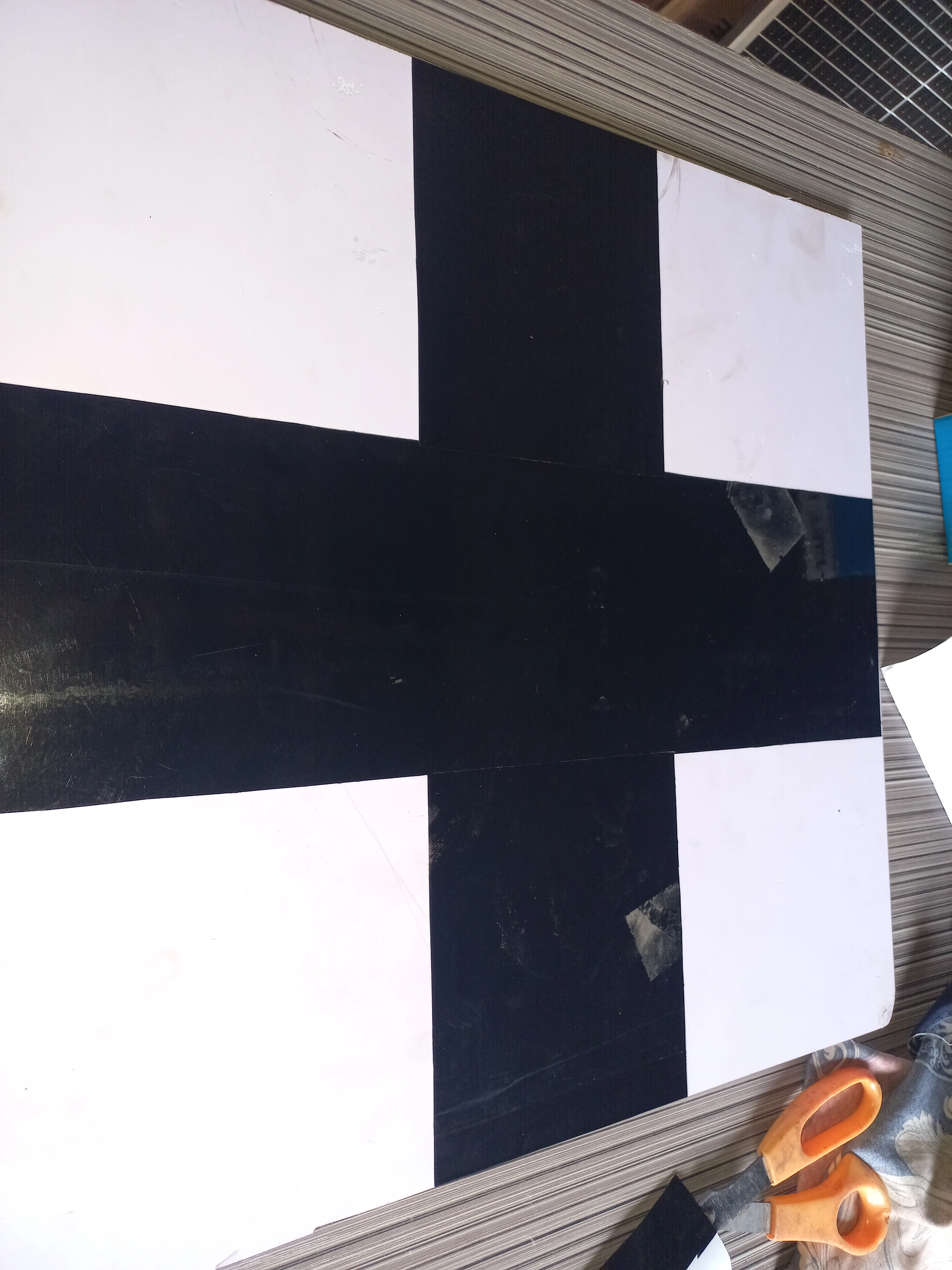 All four crossroads arms outlined with black PVC strips on the white base board