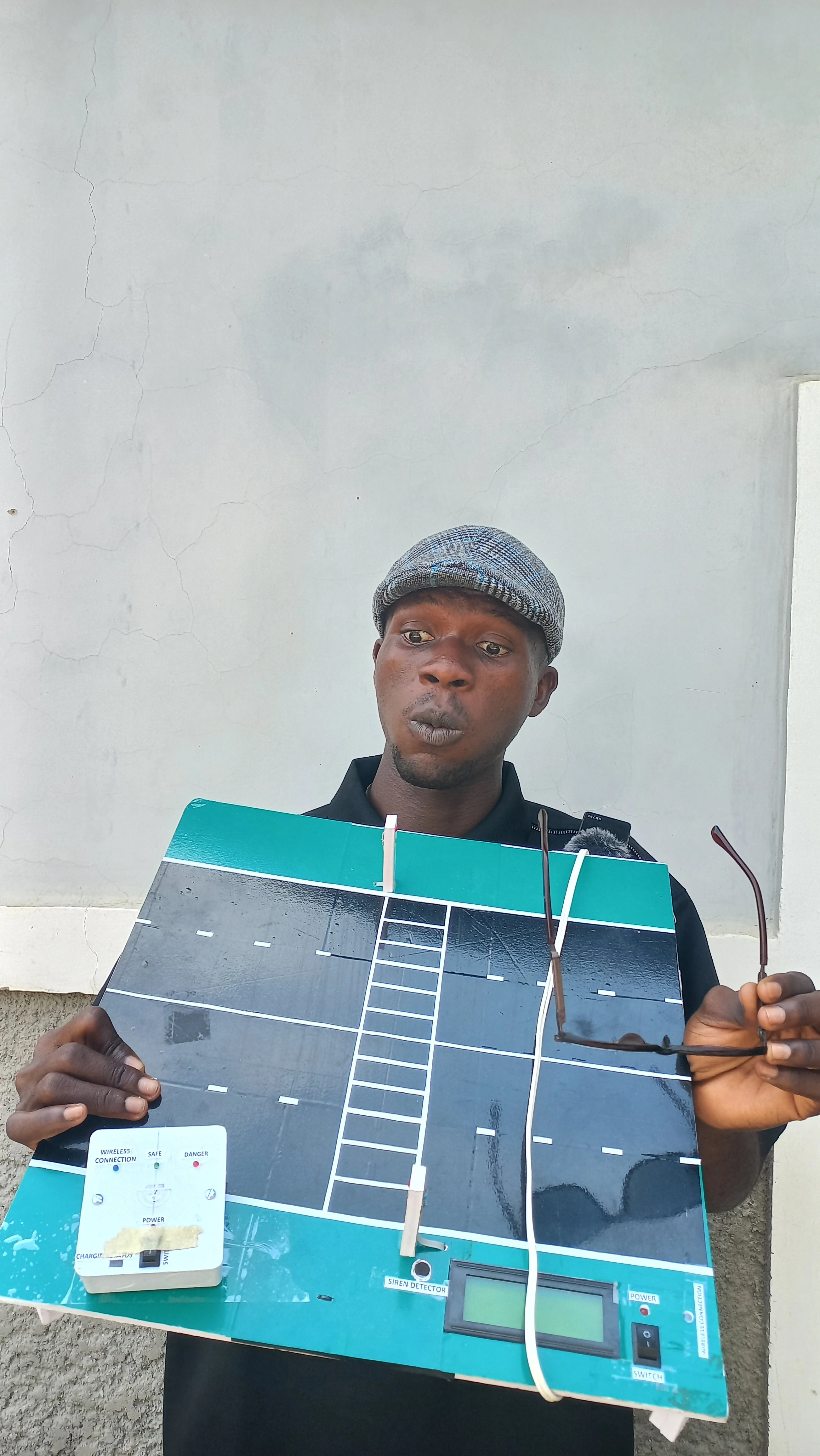 Developer holding the road model with a neutral expression for a clear view of the complete structure