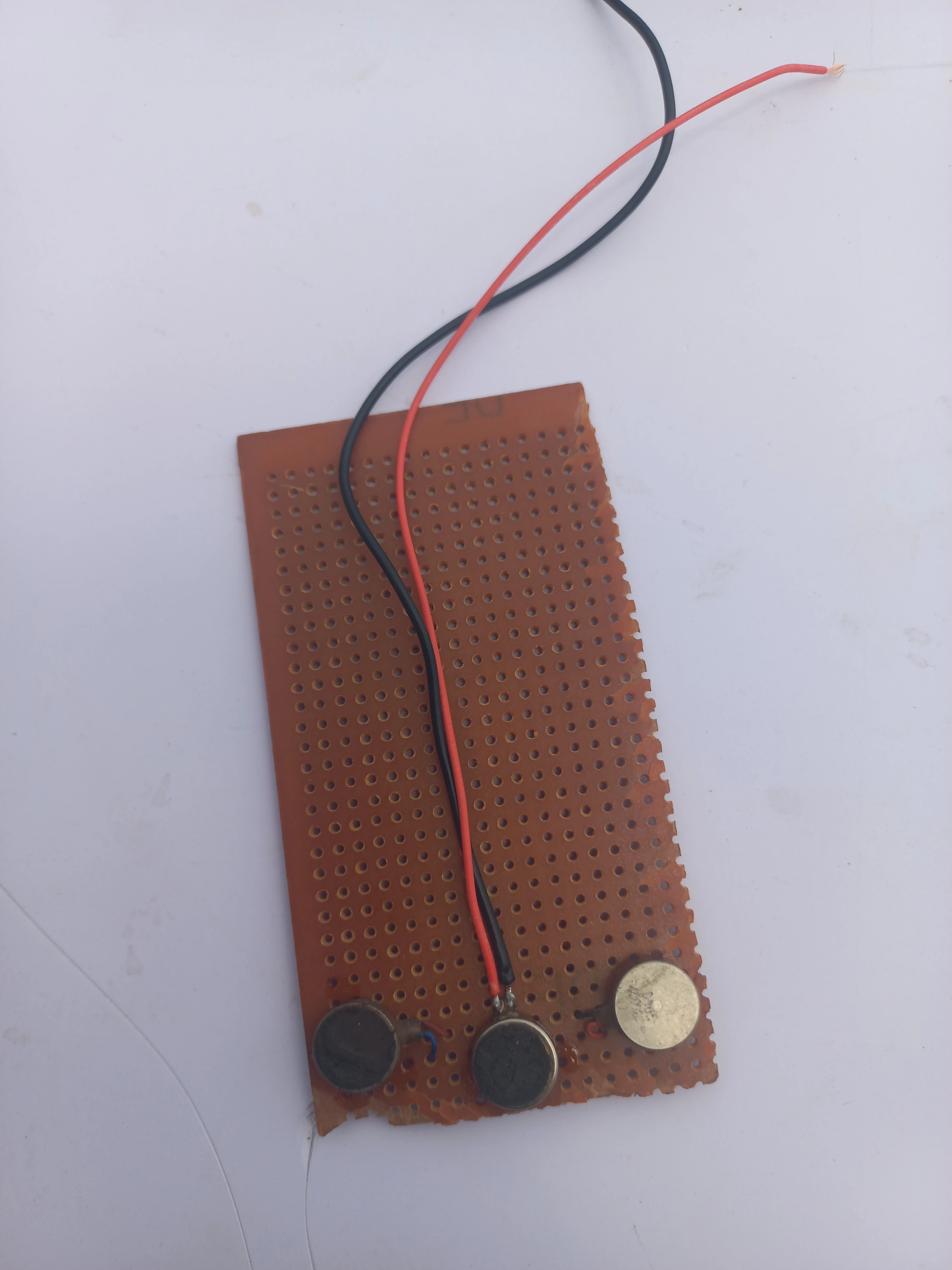 Coin vibration motor soldered onto a small perfboard sub-assembly for the wearable unit